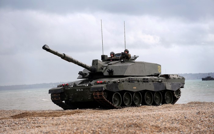 Challenger 2 tank on a beach with soldiers
