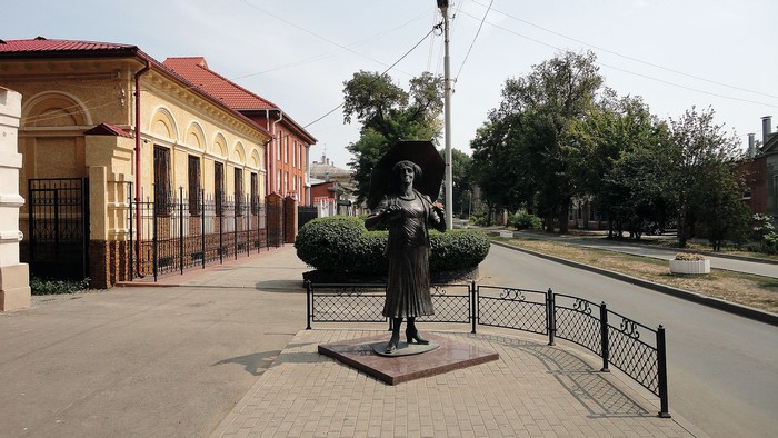 Monument of a woman holding an umbrella