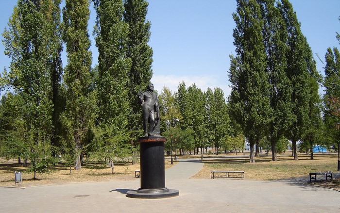 Statue in a park with tall trees