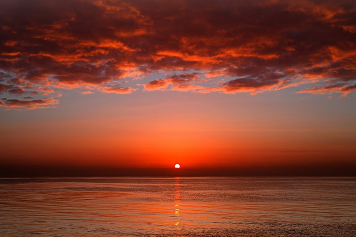 Sunset over the ocean with clouds