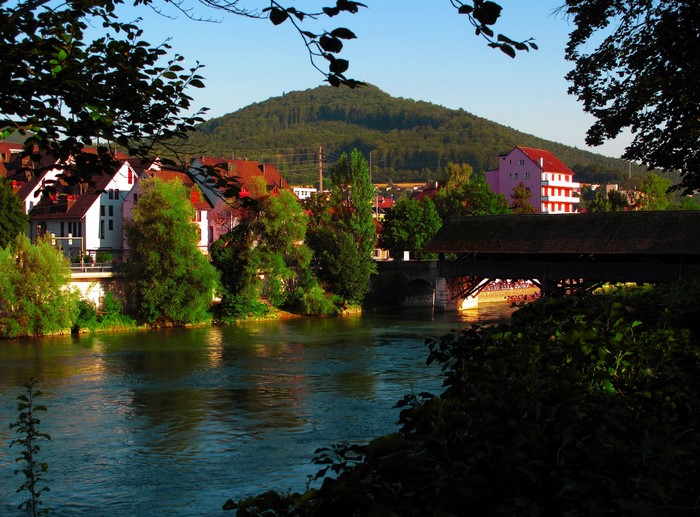 Covered bridge over a river in Switzerland