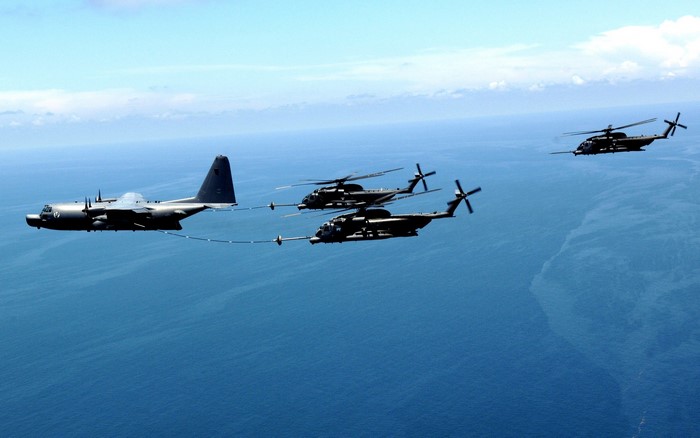 KC-130J Hercules refuels MH-53M Pave Low helicopters