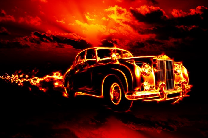 Vintage car engulfed in fire