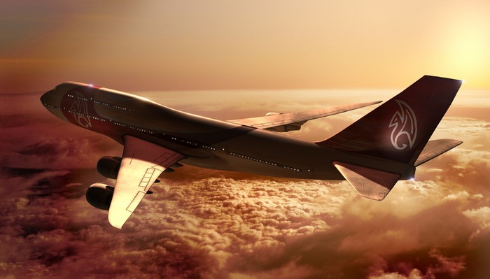 Boeing 747 airplane flying above clouds at sunset