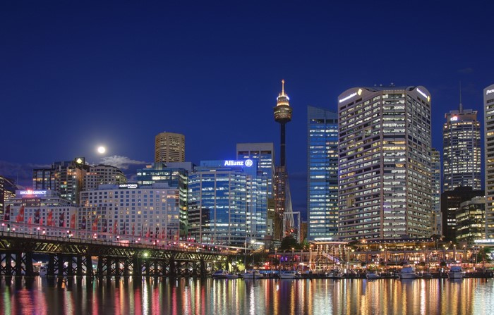 Sydney skyline at night with moon and bridge