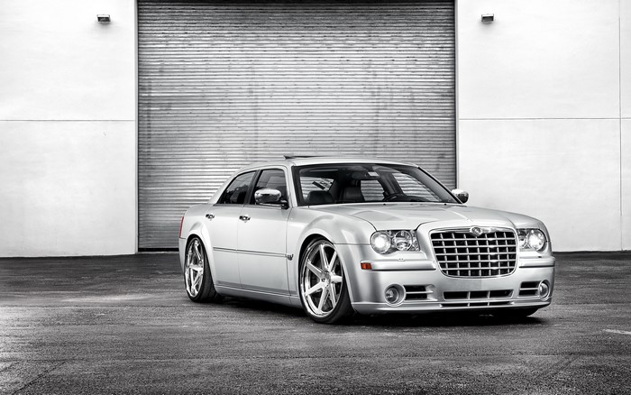 Chrysler 300 sedan parked in front of a garage door
