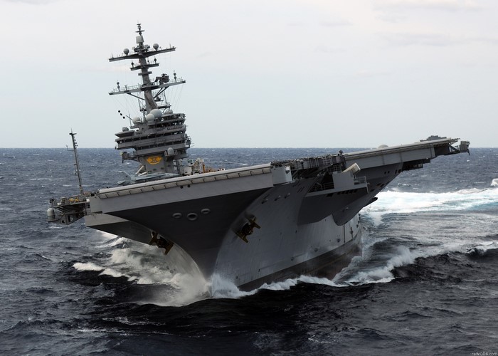 Aircraft carrier sailing through rough seas