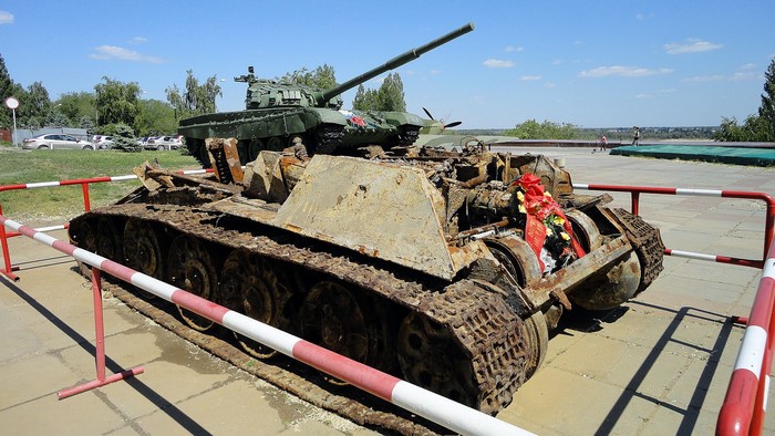 Two tanks, one destroyed, one operational, outdoors