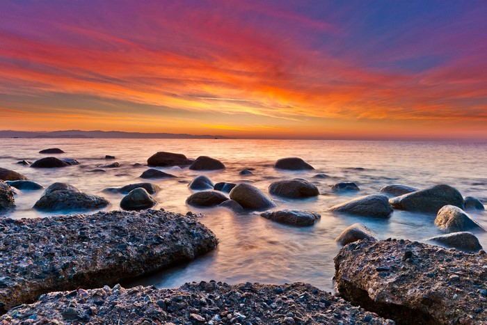 Sunset over the ocean with rocks