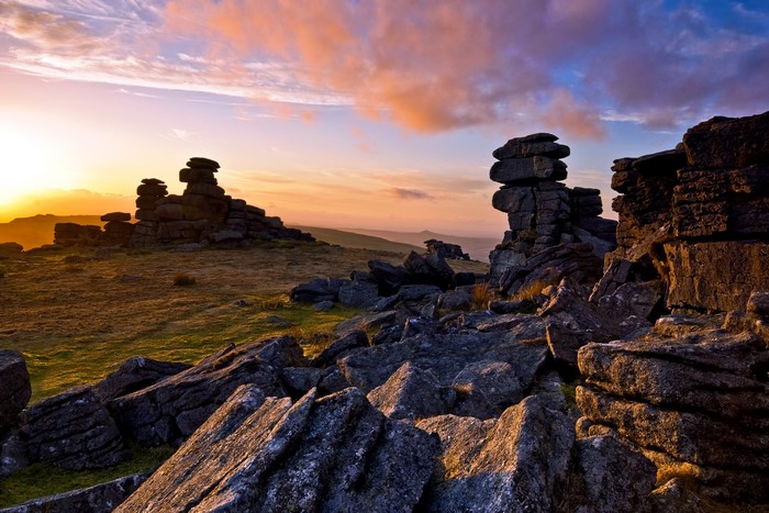 Rocky landscape at sunrise with colorful clouds