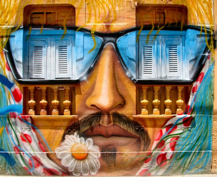 Graffiti of a man with sunglasses and a flower