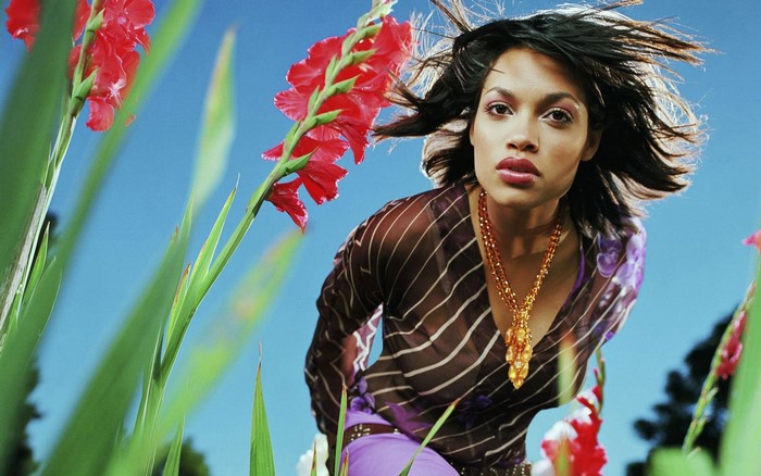 Rosario Dawson in a sheer top with gladiolus flowers