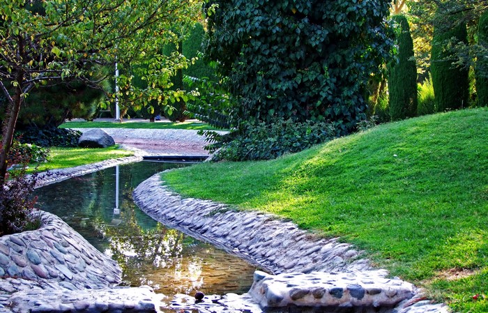 Park with a stream and manicured lawns