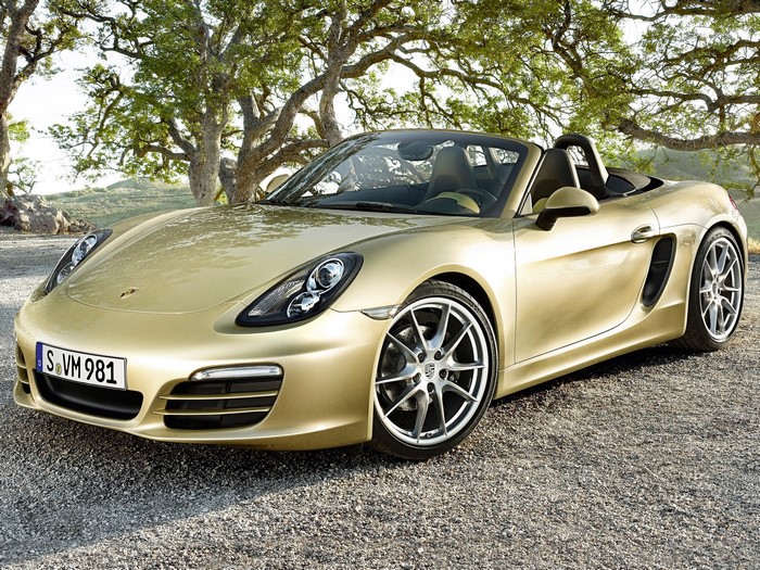 Gold Porsche Boxster convertible parked outdoors