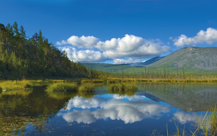 Lake with reflection of clouds and mountains
