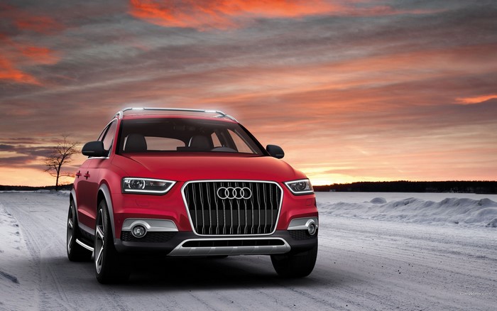 Red Audi Q3 on a Snowy Road at Sunset