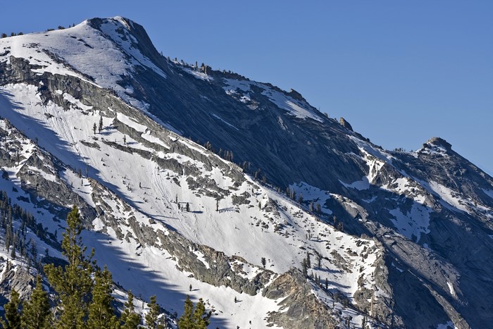 Snow-covered mountains under a clear blue sky