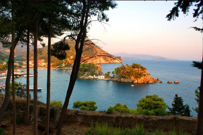 Island with a church in a bay at sunset