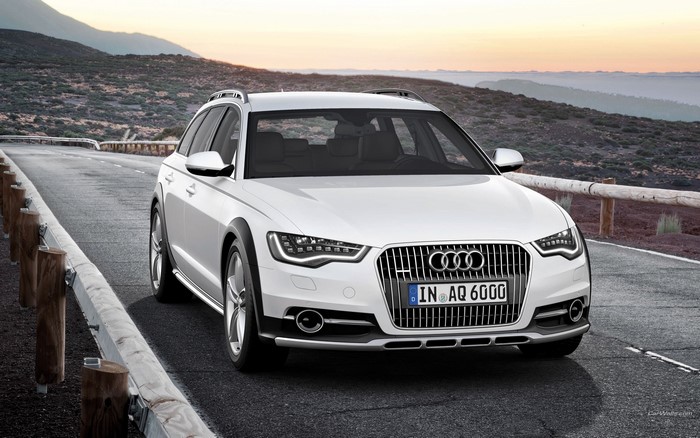 White Audi Allroad Quattro driving on a mountain road