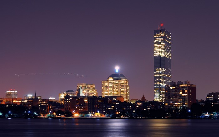 Boston skyline at night over the water
