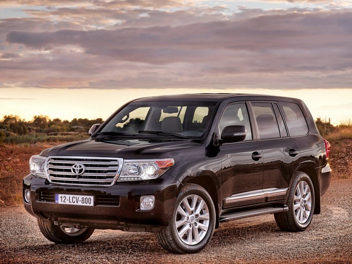 Black Toyota Land Cruiser parked on gravel road