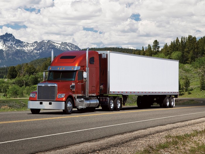 Orange Freightliner Truck with White Trailer on Road