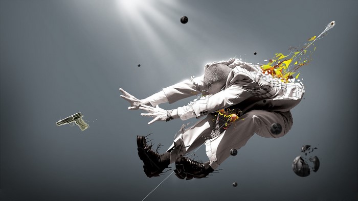 Man in suit exploding with gun and orbs