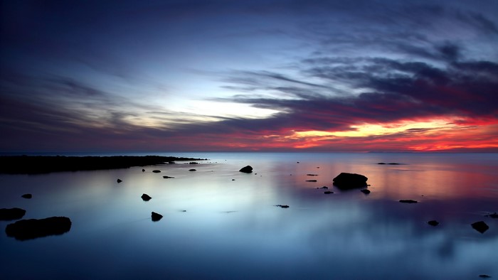 Sunset over the ocean with rocks