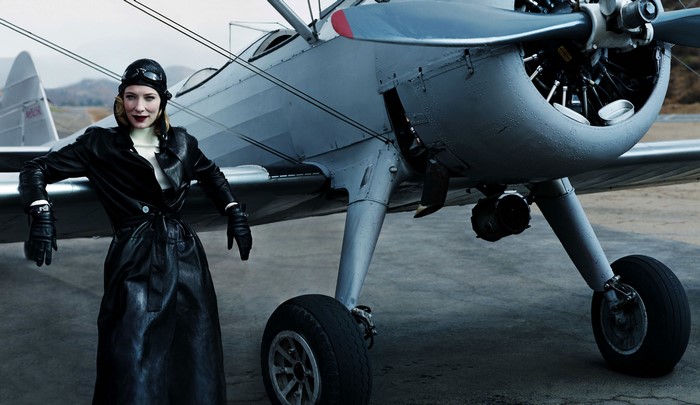 Cate Blanchett in vintage pilot attire by airplane