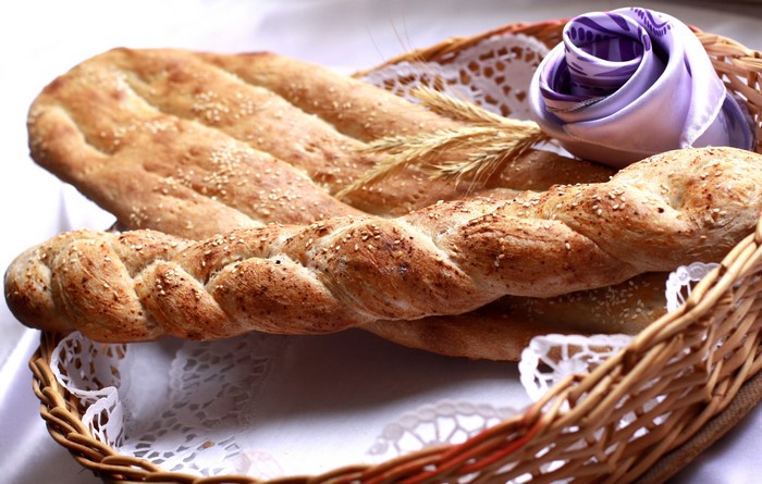 Basket of braided and flatbread with sesame seeds