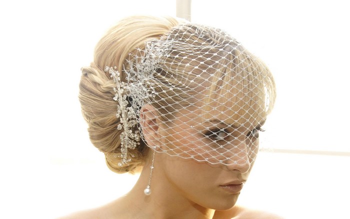 Woman with birdcage veil and pearl earring