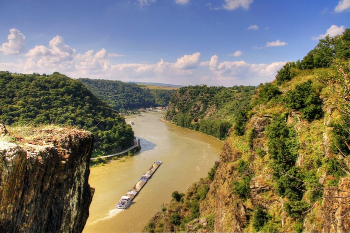 River flowing through a valley with forested hills