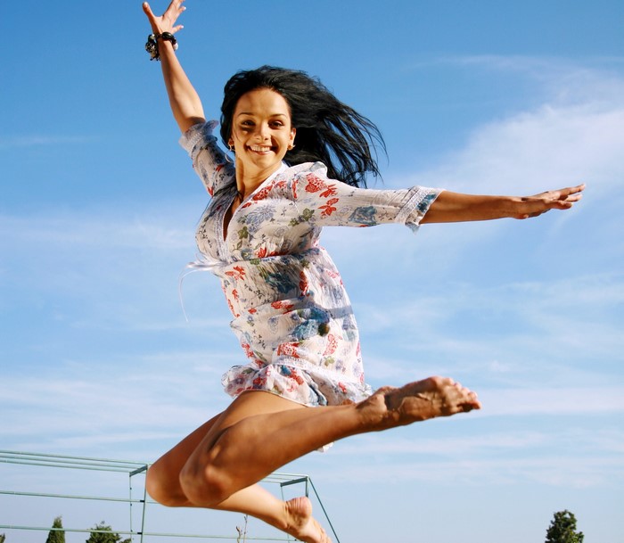 Jenya D jumping in a floral dress