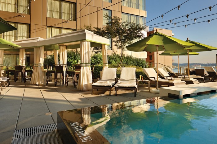 Resort pool deck with cabanas and lounge chairs