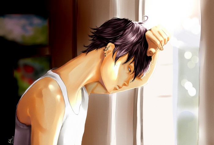 Young man leaning against a window
