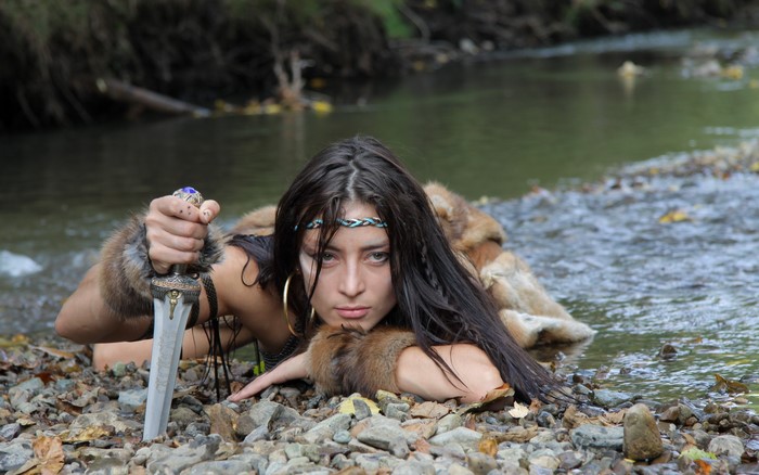 Woman with sword in river