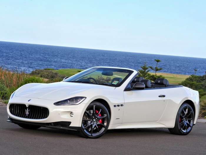 White Maserati GranCabrio convertible by the ocean