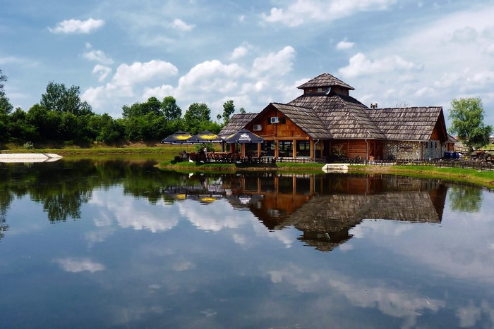Wooden building by a lake in Etno selo Moravski konaci, Serbia