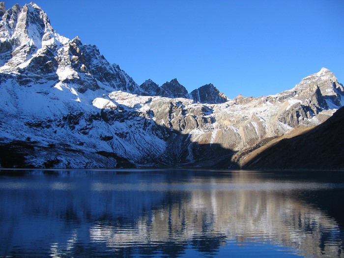 Snow-capped mountains reflected in a lake in Sagarmatha National Park