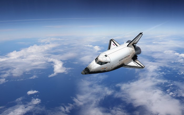 Space Shuttle flying above clouds