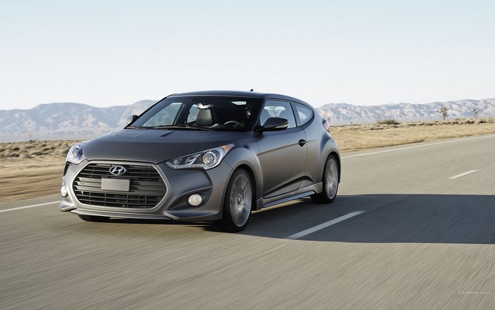 Hyundai Veloster driving on a desert road