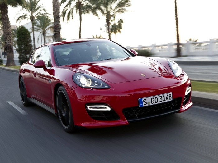 Red Porsche Panamera driving on a road