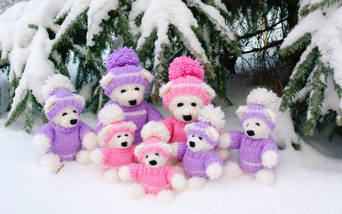 Knitted teddy bears in winter snow