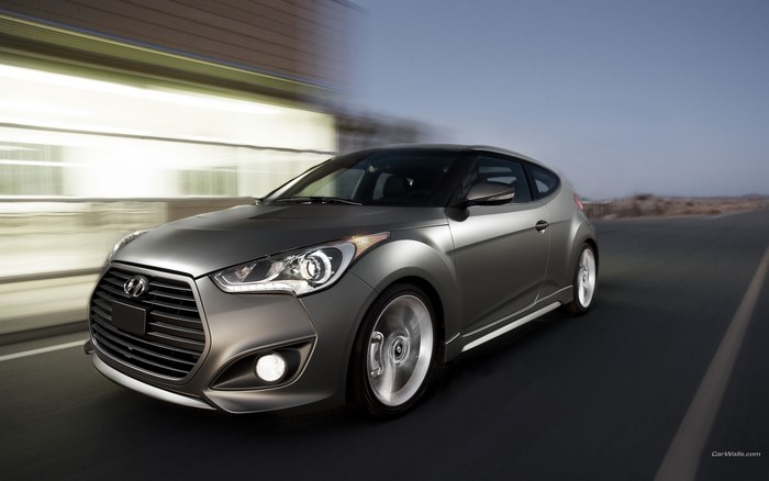 Hyundai Veloster driving on a road
