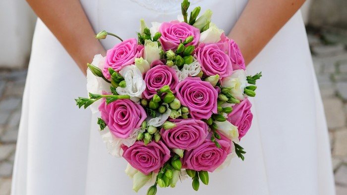Bride holding pink and white rose bouquet