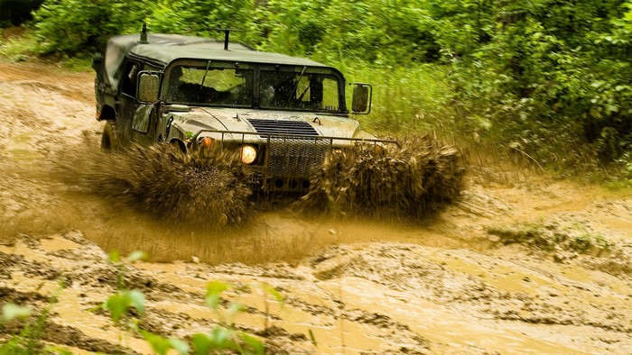 Hummer driving through mud