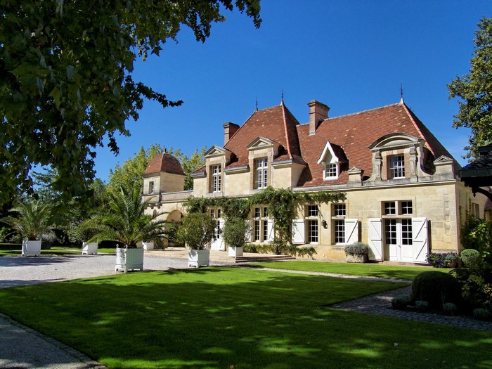 French Chateau with manicured gardens and palm trees