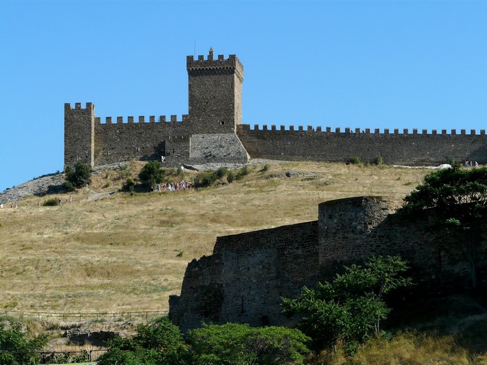 Genoese fortress on a hill under a clear blue sky