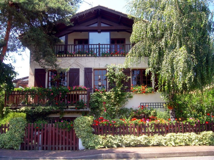 House with balconies and flowers in France