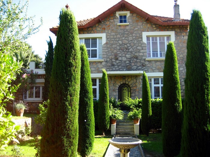 Stone house with cypress trees in France